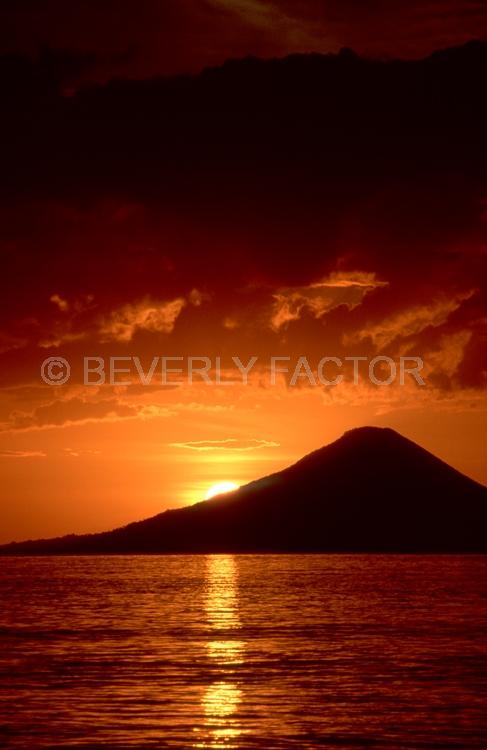 (Multiple values);sun;water;sillouettes;volcano;reflections;colorful;papua new guinea